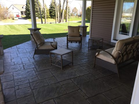Covered stamped concrete patio with outdoor furniture
