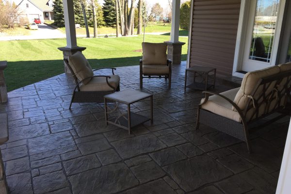 Covered stamped concrete patio with outdoor furniture