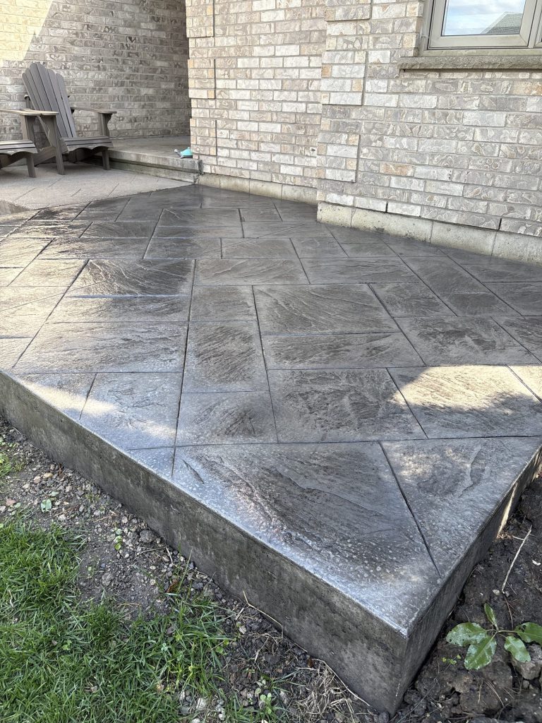 Raised stamped concrete patio with a formed step edge