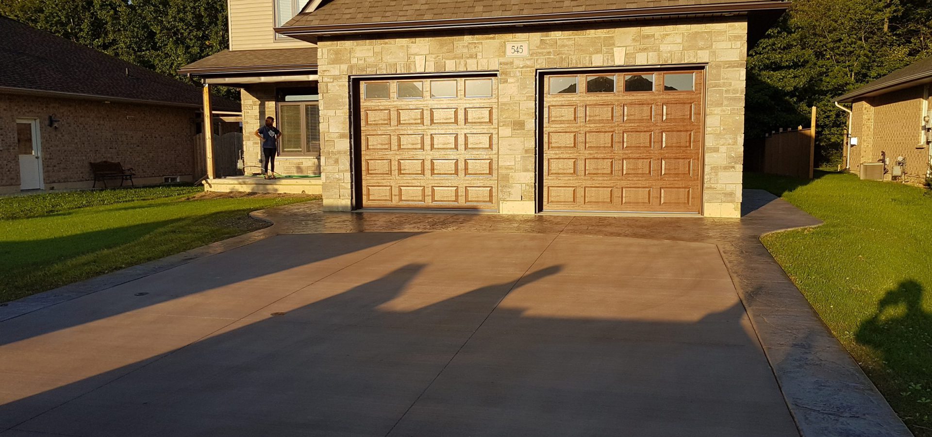 Stamped concrete driveway in front of a two-car garage