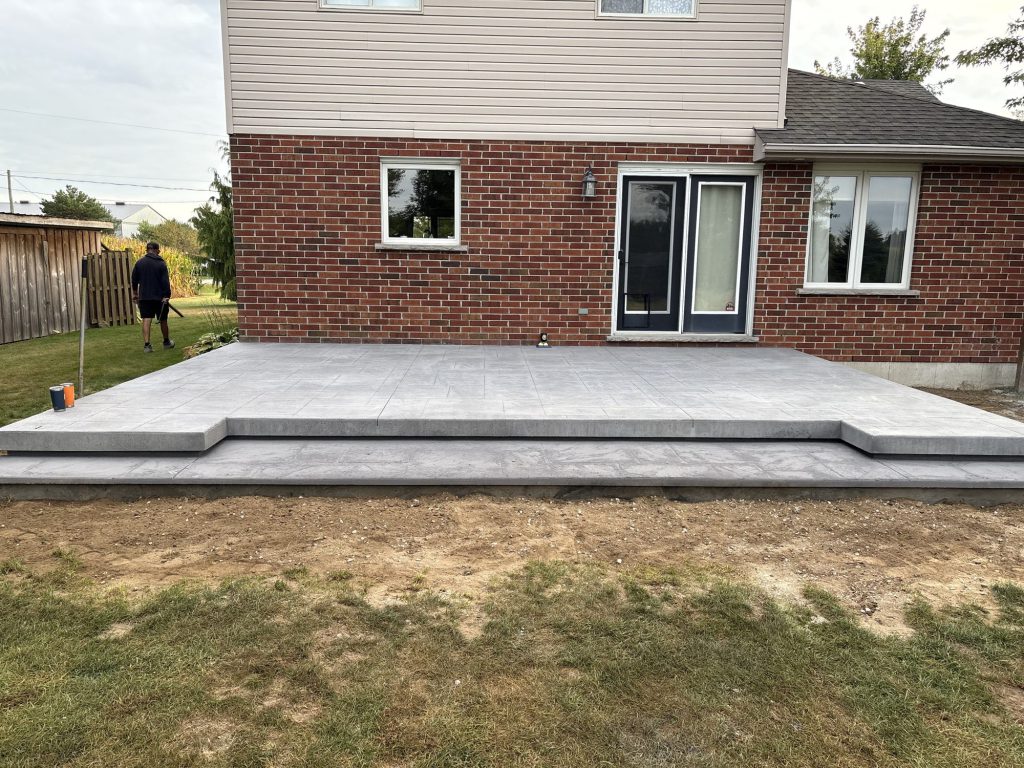 SWCI crew finishing a backyard concrete patio pour